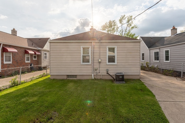 rear view of property featuring central air condition unit