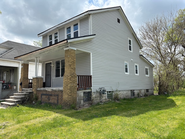 17233 Fenelon St, Hamtramck, MI 48212 - view of property exterior with a porch and a yard