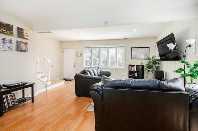 living room with stairs, light wood finished floors, recessed lighting, and baseboards