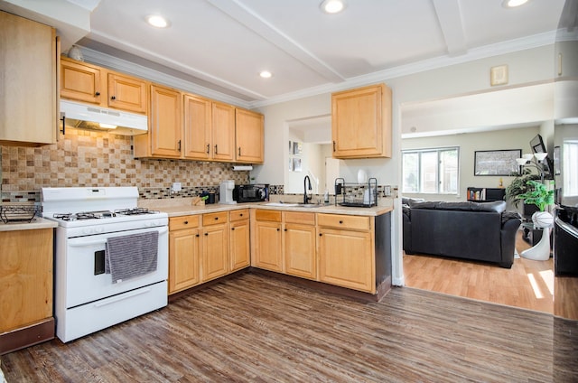kitchen featuring white range with gas cooktop, under cabinet range hood, a sink, light brown cabinets, and dark wood-style flooring