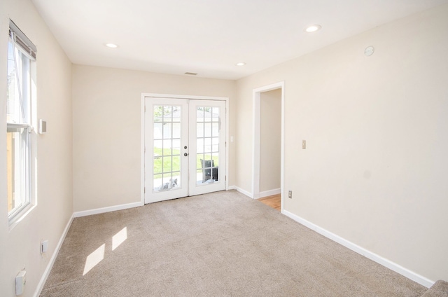 empty room with french doors, carpet flooring, baseboards, and recessed lighting