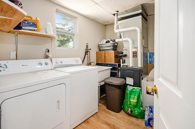 laundry room featuring light wood-style floors and separate washer and dryer