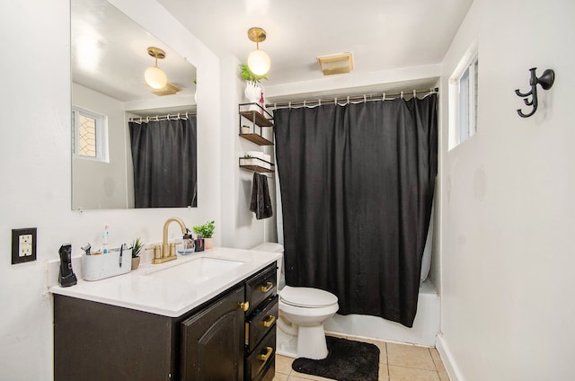 bathroom with tile patterned floors, toilet, vanity, shower / bath combination with curtain, and baseboards