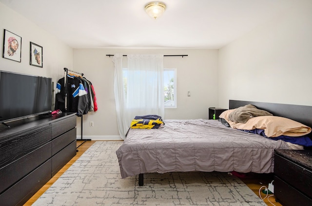 bedroom featuring light wood-type flooring and baseboards