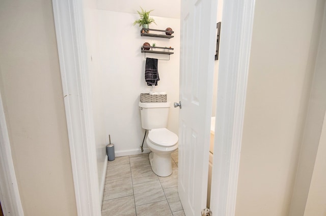 bathroom with toilet and tile patterned flooring