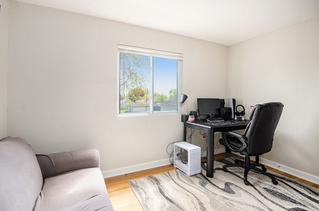 office area featuring light wood-style flooring and baseboards