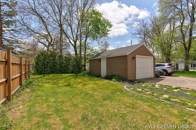 188 W 21st St, Holland, MI 49423 - view of yard featuring an outdoor structure, driveway, and a detached garage