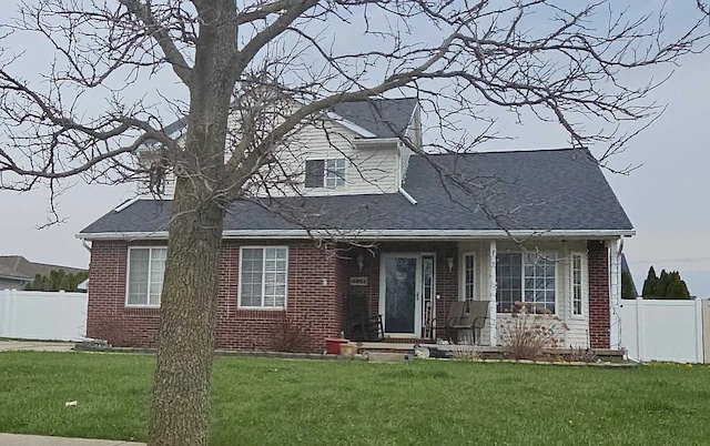 view of front facade with brick siding and roof with shingles
