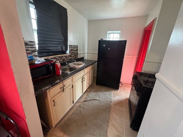 14611 Washburn St, Detroit, MI 48238 - kitchen with black appliances, dark countertops, tasteful backsplash, and a sink