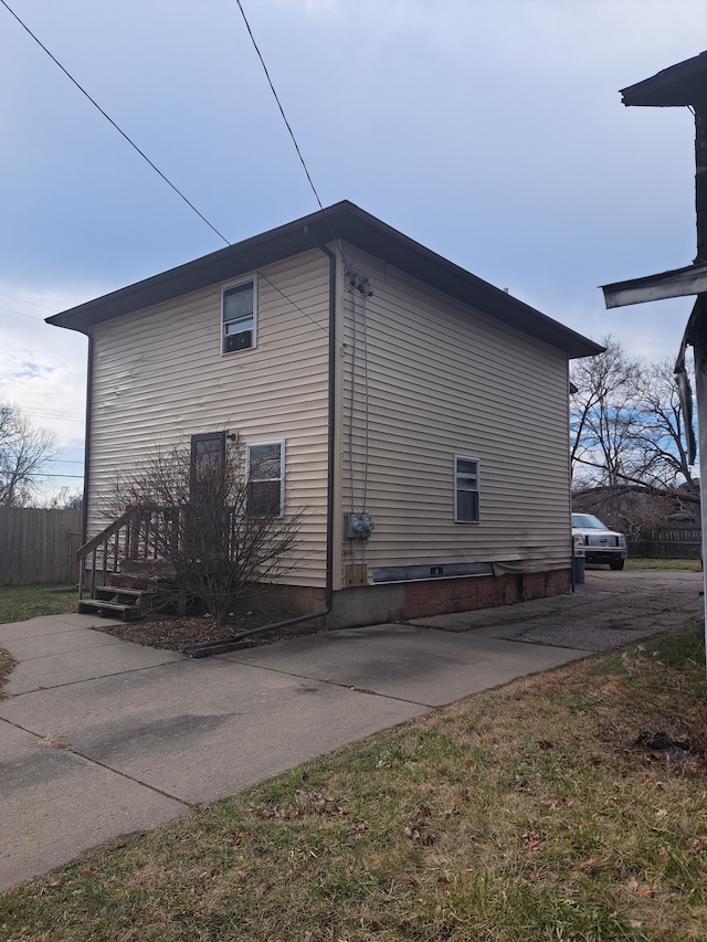 view of side of home with fence