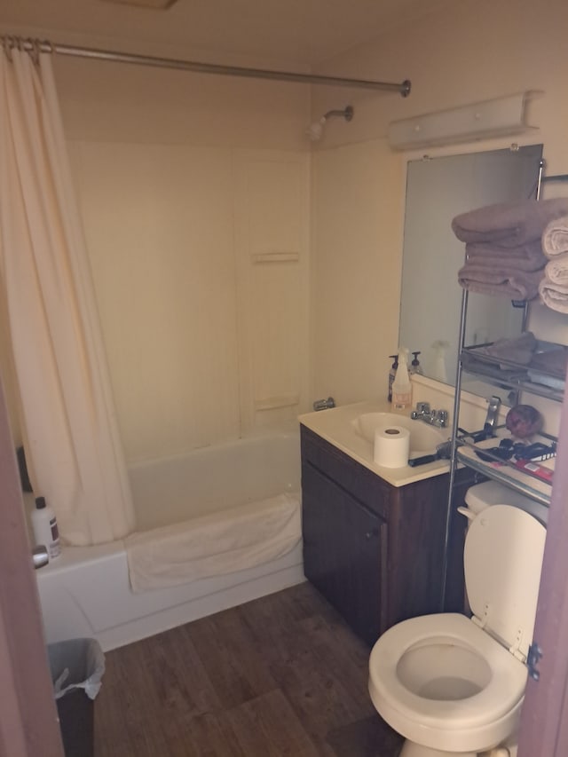 full bathroom featuring shower / tub combo, wood finished floors, vanity, and toilet