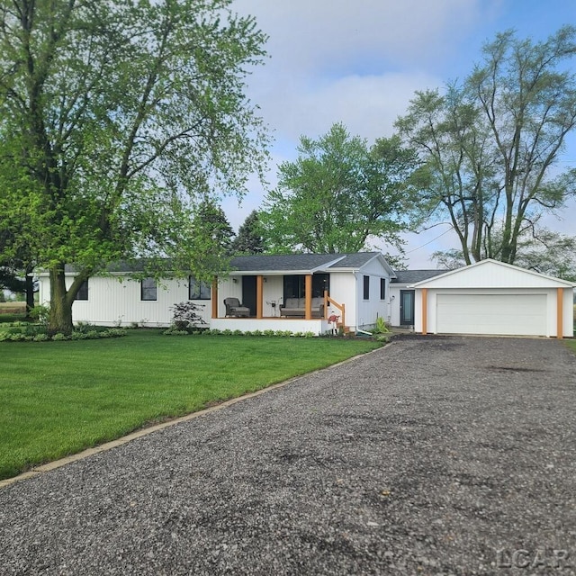 ranch-style house with a front yard, covered porch, and gravel driveway
