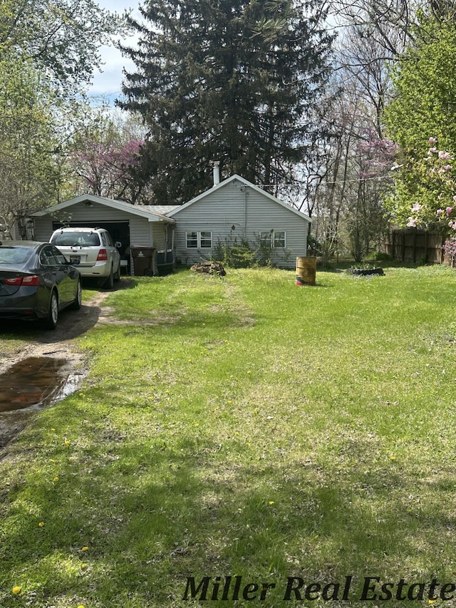 7755 Woodland Rd, Lake Odessa, MI 48849 - view of yard featuring a garage and driveway