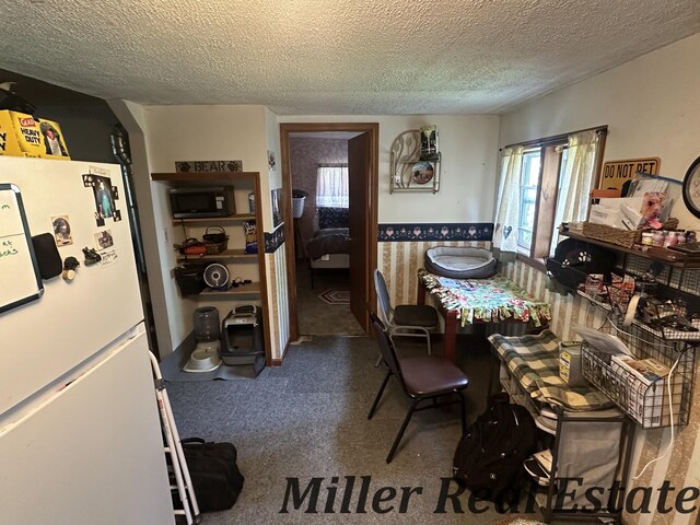 7755 Woodland Rd, Lake Odessa, MI 48849 - dining room featuring a textured ceiling, carpet floors, and a wainscoted wall