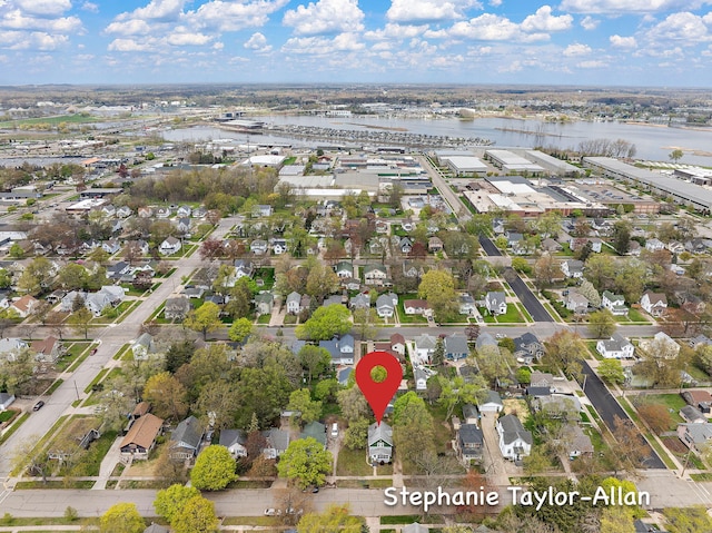 view of property location featuring a nearby body of water and nearby suburban area