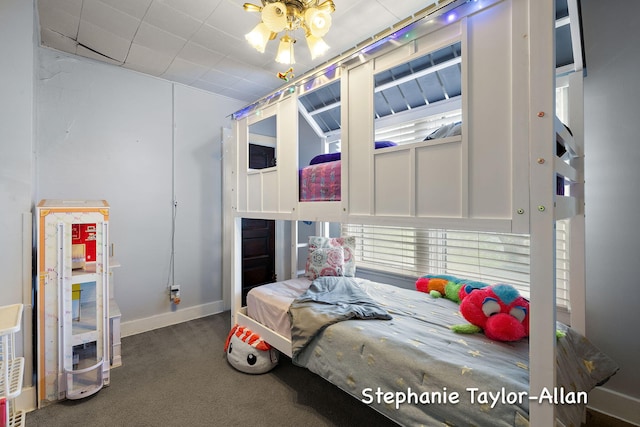 carpeted bedroom featuring baseboards