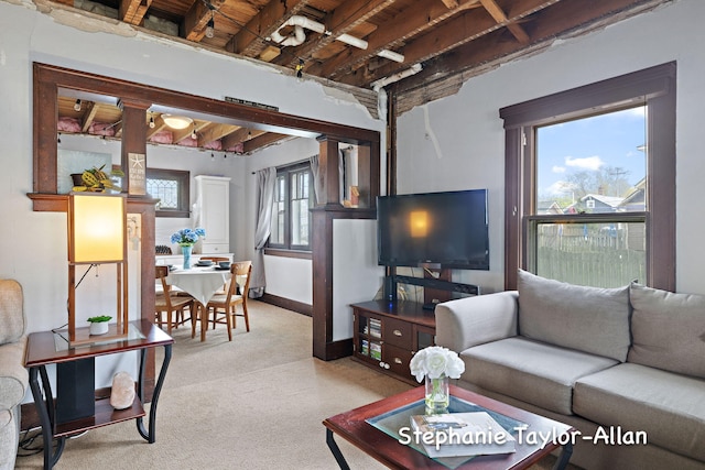 carpeted living area with baseboards