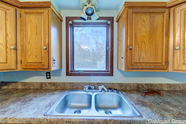 kitchen featuring a sink and brown cabinetry