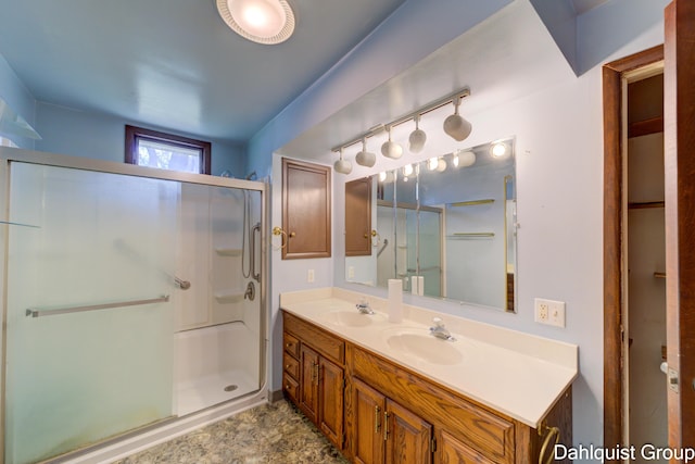 full bathroom with a shower stall and double vanity