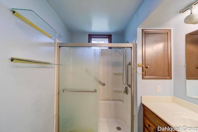full bathroom with a shower stall and vanity