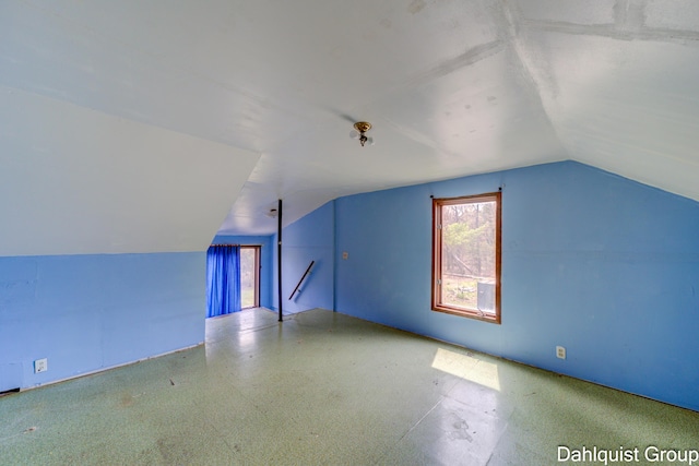 additional living space featuring vaulted ceiling