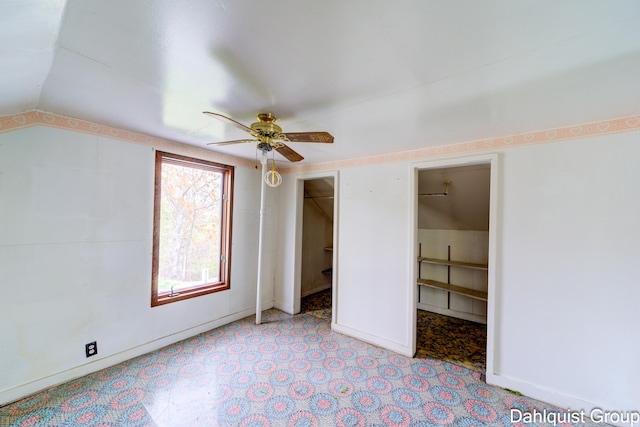 unfurnished bedroom featuring lofted ceiling and ceiling fan