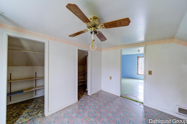 unfurnished bedroom featuring ceiling fan, baseboards, and lofted ceiling