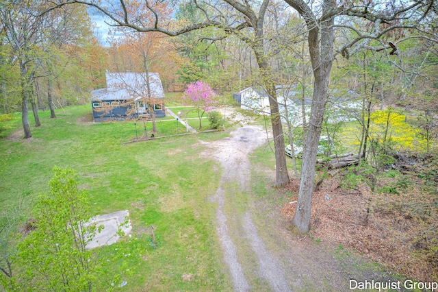 view of subject property with a heavily wooded area