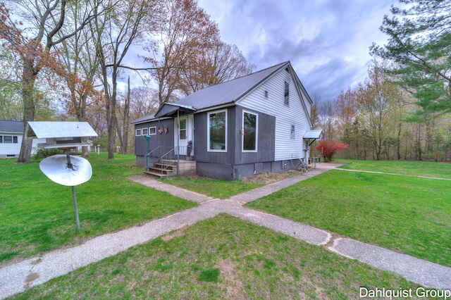bungalow-style home with a front yard and metal roof