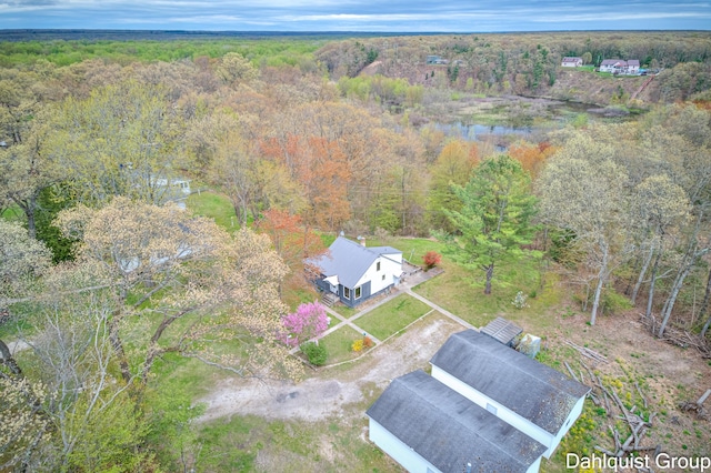 view of subject property with a heavily wooded area and a large body of water