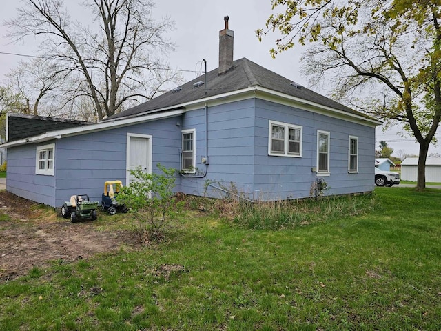 335 Emory St, Howard City, MI 49329 - view of side of home featuring a chimney and a lawn