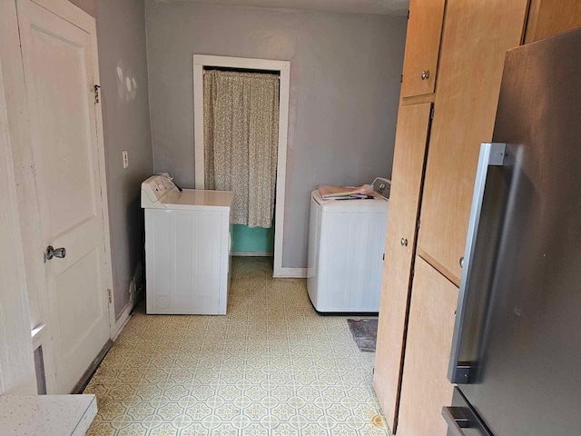 335 Emory St, Howard City, MI 49329 - laundry room with washing machine and clothes dryer and baseboards