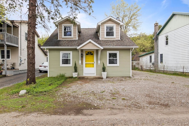 cape cod-style house featuring a shingled roof