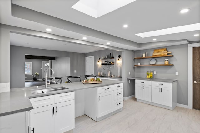 kitchen featuring a sink, open shelves, white cabinetry, recessed lighting, and light marble finish floors