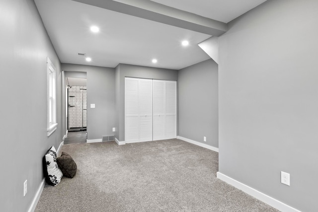 unfurnished bedroom with baseboards, carpet flooring, recessed lighting, and a closet