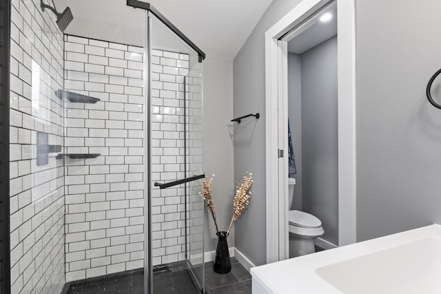 full bathroom with a shower stall and toilet