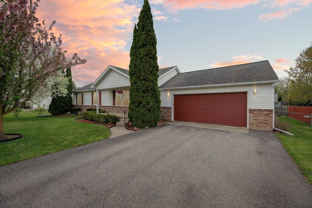 9361 Summerland Dr, Whitmore Lake, MI 48189 - view of front of property featuring brick siding, driveway, and a garage