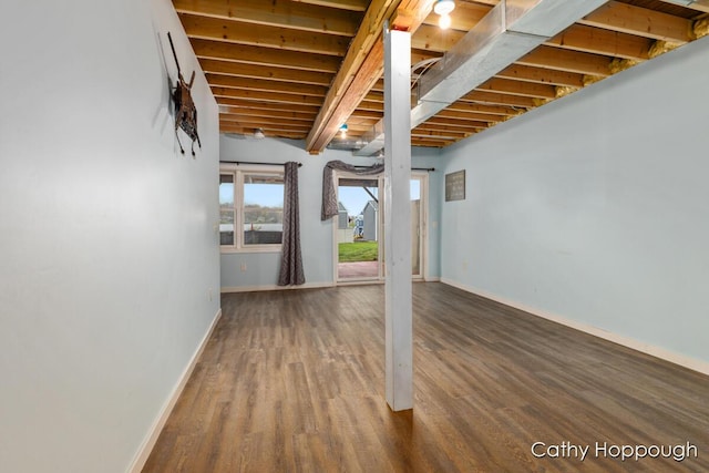 basement with baseboards and wood finished floors
