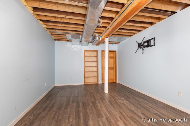 unfinished below grade area featuring wood finished floors and baseboards