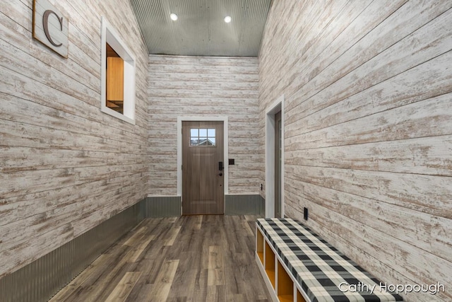 foyer entrance with recessed lighting, dark wood-style floors, wooden ceiling, and wood walls