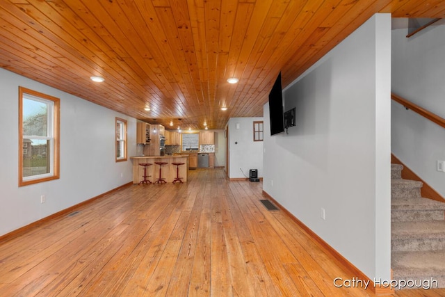 unfurnished living room featuring light wood finished floors, wood ceiling, stairway, recessed lighting, and baseboards