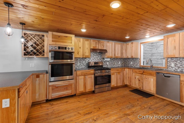 kitchen with stainless steel appliances, under cabinet range hood, light brown cabinets, a sink, and wooden ceiling