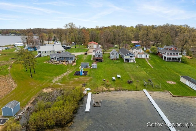 aerial view of residential area featuring a nearby body of water