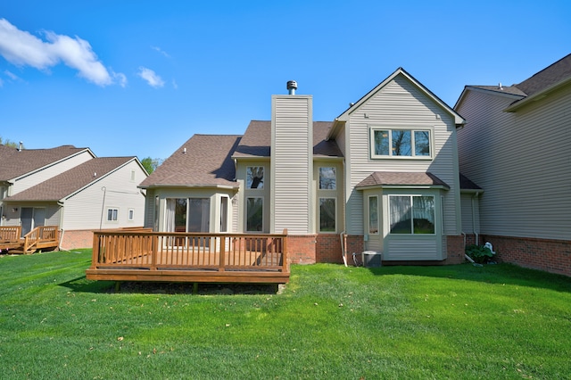 back of house with a chimney, a wooden deck, a yard, and central AC