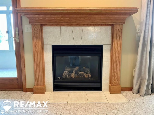 detailed view of a tiled fireplace and baseboards