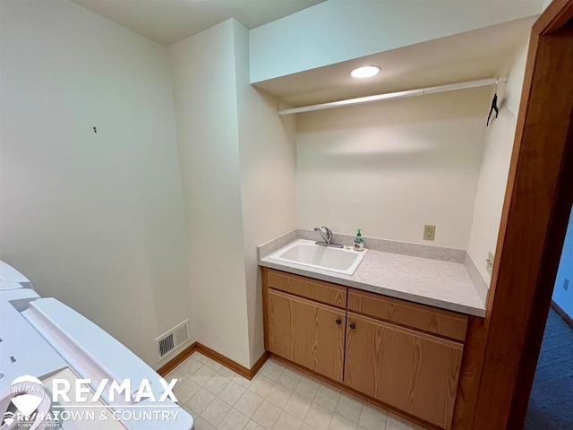 bathroom with vanity, baseboards, and recessed lighting