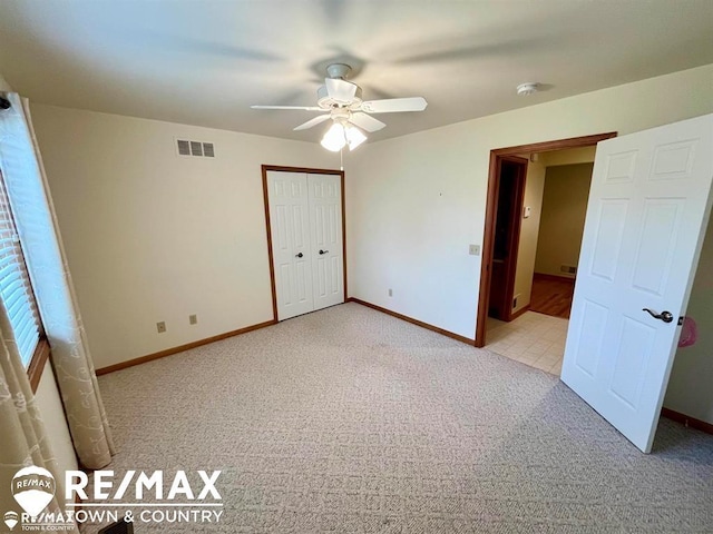 unfurnished bedroom with carpet floors and baseboards