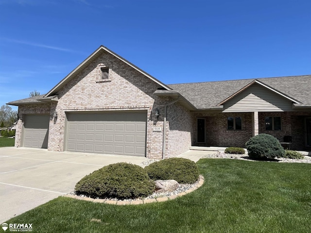 ranch-style home featuring brick siding, a garage, roof with shingles, and concrete driveway