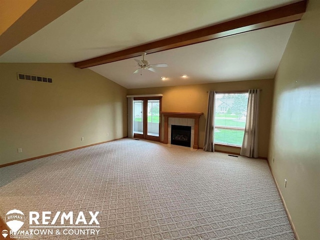 unfurnished living room with carpet, ceiling fan, a tile fireplace, and baseboards