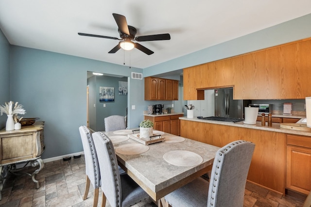 4630 Pasture Ln, White Lake, MI 48383 - dining area with ceiling fan, stone finish flooring, and baseboards